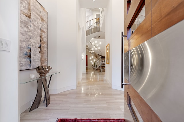 15618 Oyster Cove Dr, Sugar Land, TX 77478 - hallway with arched walkways, stairway, and a towering ceiling