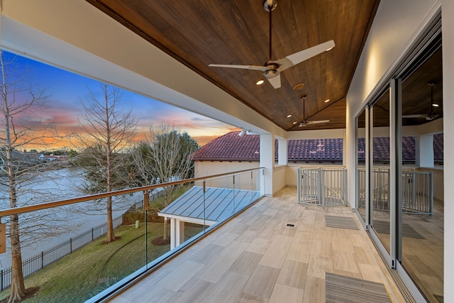 15618 Oyster Cove Dr, Sugar Land, TX 77478 - patio terrace at dusk with ceiling fan, a balcony, and a water view