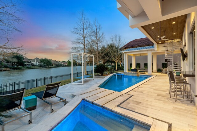 15618 Oyster Cove Dr, Sugar Land, TX 77478 - view of pool featuring a ceiling fan, an outdoor bar, a patio area, and a water view