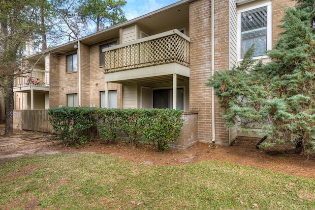 3500 Tangle Brush Dr Unit 7, The Woodlands, TX 77381 - exterior space featuring brick siding, a yard, and a balcony