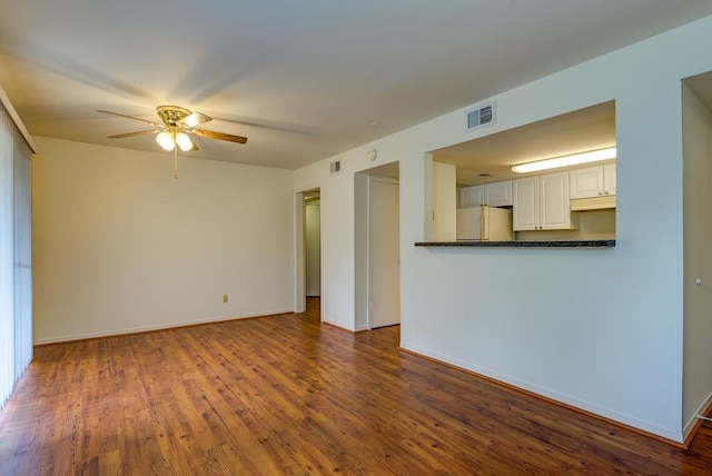 3500 Tangle Brush Dr Unit 7, The Woodlands, TX 77381 - unfurnished living room featuring visible vents, ceiling fan, and wood finished floors