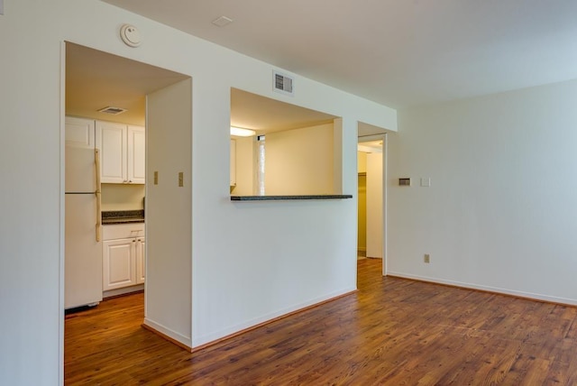 3500 Tangle Brush Dr Unit 7, The Woodlands, TX 77381 - empty room featuring baseboards, wood finished floors, and visible vents