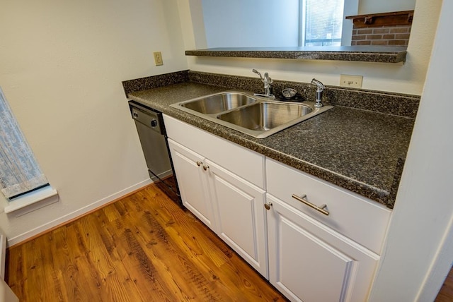 3500 Tangle Brush Dr Unit 7, The Woodlands, TX 77381 - kitchen with dark countertops, a sink, white cabinetry, baseboards, and dishwashing machine