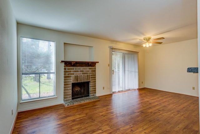 3500 Tangle Brush Dr Unit 7, The Woodlands, TX 77381 - unfurnished living room featuring baseboards, a ceiling fan, wood finished floors, and a fireplace