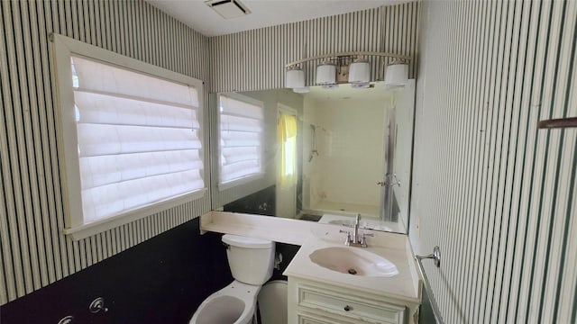 bathroom with vanity, visible vents, toilet, and wallpapered walls