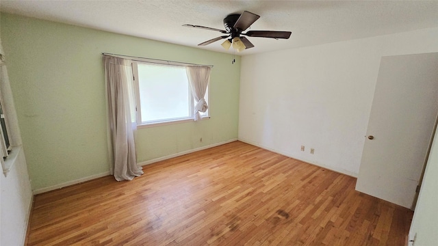 unfurnished bedroom with a ceiling fan and light wood-type flooring
