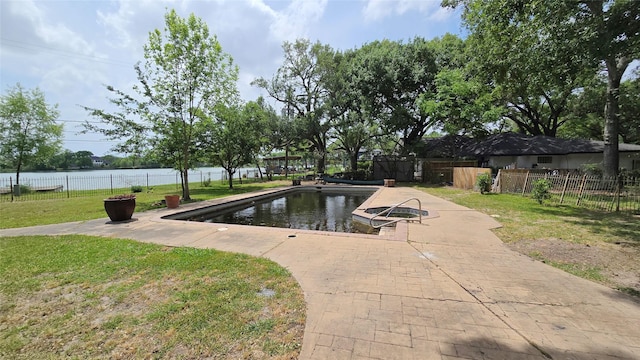 view of pool with a yard, a water view, fence, and a boat dock