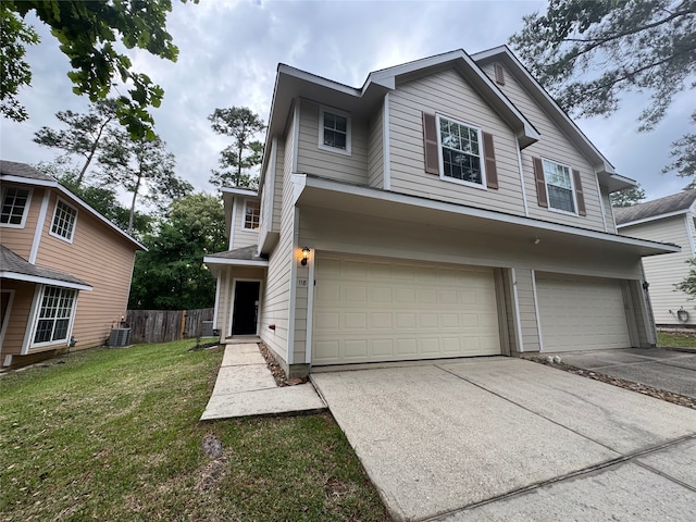 view of front facade featuring driveway, a garage, central air condition unit, fence, and a front lawn