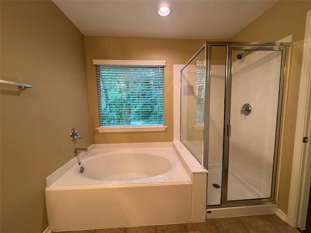 full bath featuring tile patterned flooring, a garden tub, and a shower stall