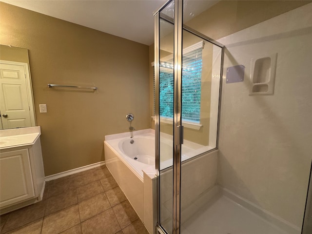 full bath featuring a stall shower, tile patterned floors, a bath, and vanity