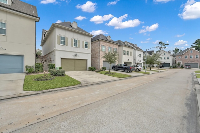 258 Green Blvd, Shenandoah, TX 77384 - view of front facade featuring an attached garage, driveway, a residential view, and stucco siding