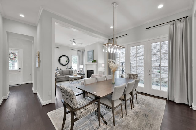 258 Green Blvd, Shenandoah, TX 77384 - dining area with crown molding, a ceiling fan, dark wood-style floors, and a fireplace