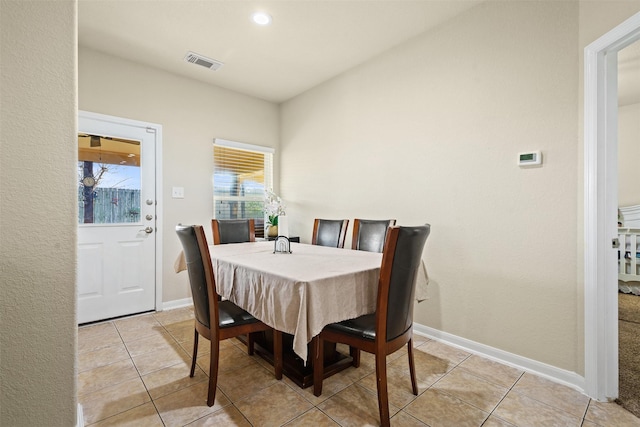 dining area with light tile patterned floors, baseboards, and visible vents