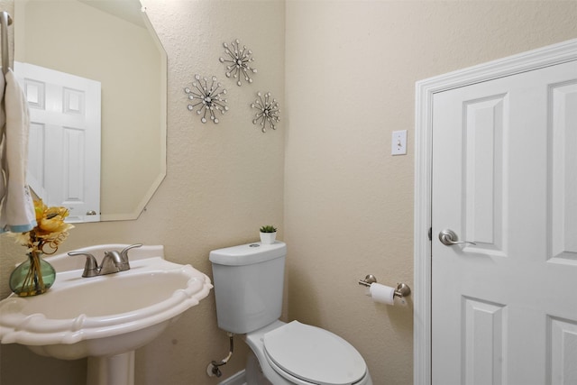 bathroom featuring toilet and a sink