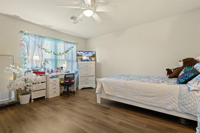 bedroom with visible vents, a ceiling fan, and wood finished floors