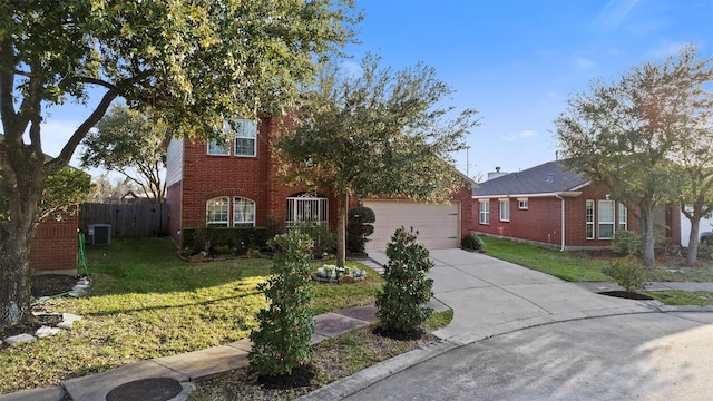 view of property hidden behind natural elements with fence, an attached garage, brick siding, a front yard, and driveway
