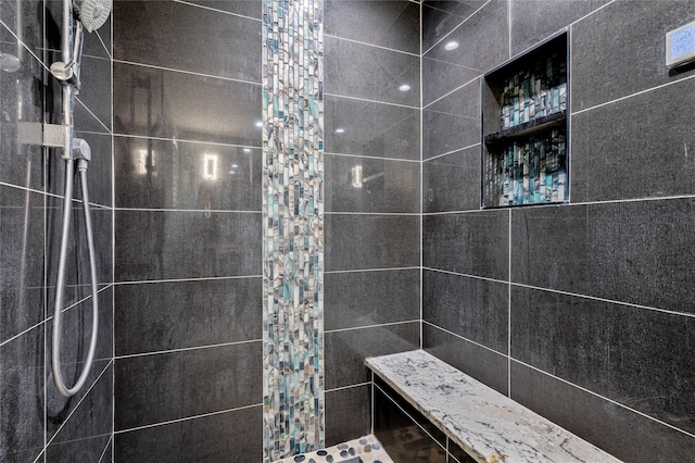 bathroom with a tile shower