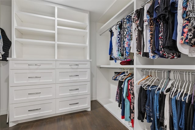 walk in closet with dark wood-type flooring