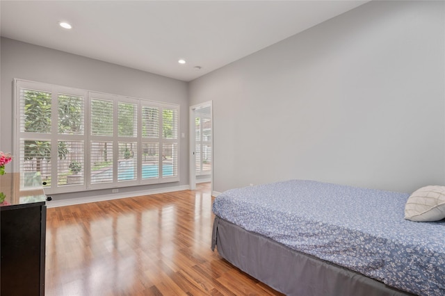 bedroom with recessed lighting, multiple windows, and light wood-style floors