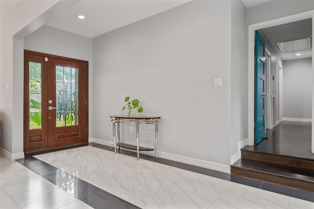 foyer with recessed lighting, baseboards, and marble finish floor