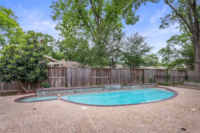 view of swimming pool featuring a fenced in pool, a fenced backyard, and a patio area