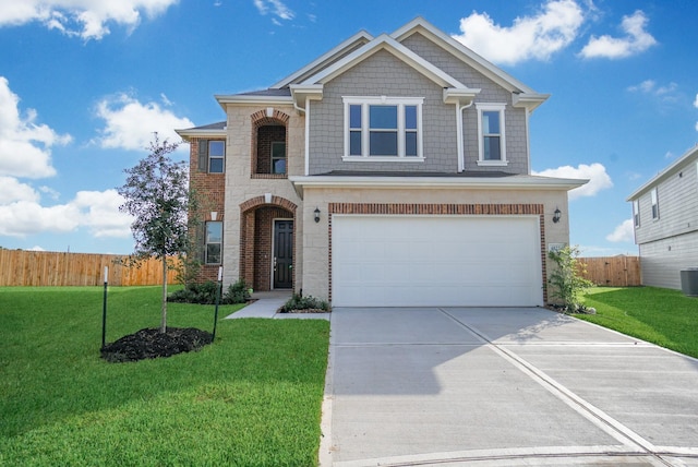 view of front of property with fence, an attached garage, concrete driveway, and a front yard