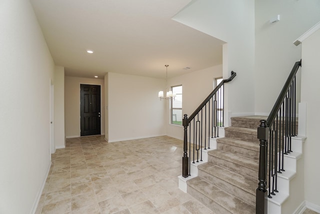 stairway with recessed lighting, baseboards, and a notable chandelier