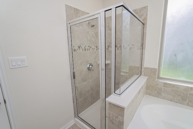 full bathroom with a stall shower and a garden tub
