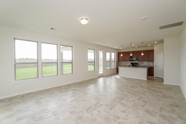 unfurnished living room with recessed lighting, baseboards, and visible vents
