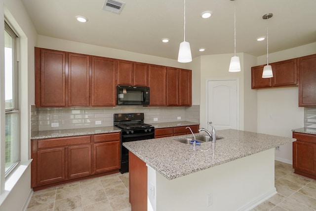 kitchen featuring a sink, decorative light fixtures, decorative backsplash, visible vents, and black appliances