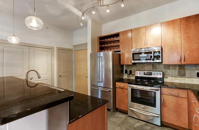 kitchen with decorative backsplash, brown cabinetry, and stainless steel appliances
