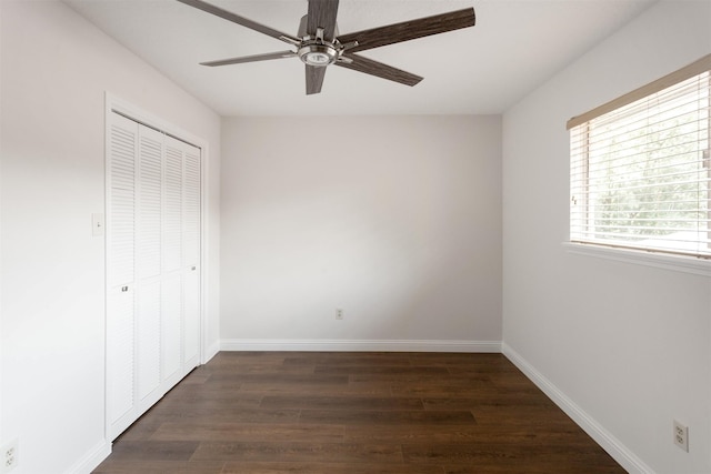unfurnished bedroom with baseboards, ceiling fan, a closet, and wood finished floors