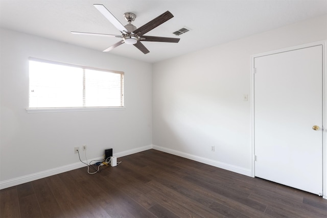 unfurnished room with a ceiling fan, baseboards, visible vents, and wood finished floors