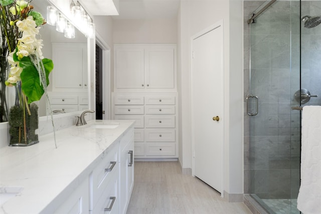 bathroom featuring vanity and a shower stall
