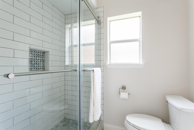 full bath with toilet and a shower stall