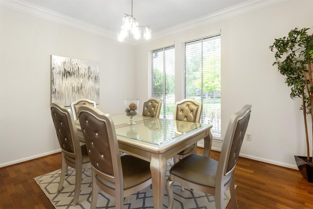 dining space featuring crown molding, baseboards, wood finished floors, and a chandelier