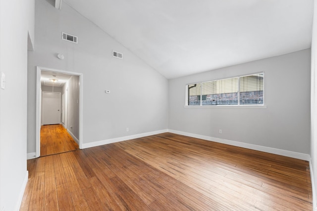 unfurnished room featuring attic access, hardwood / wood-style flooring, and visible vents