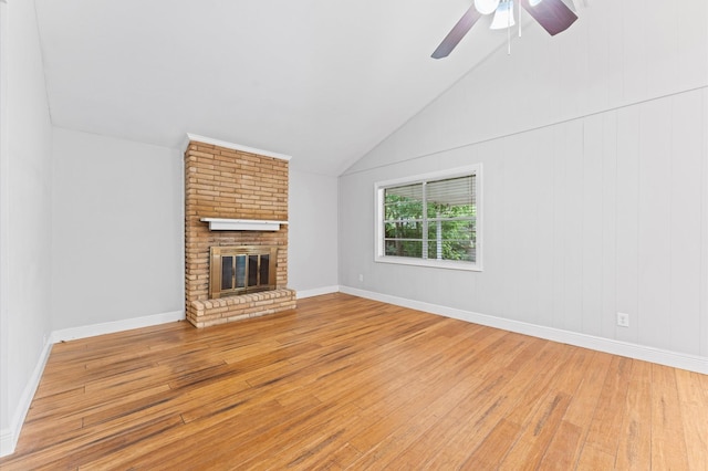 unfurnished living room with a fireplace, a ceiling fan, light wood-style flooring, and lofted ceiling