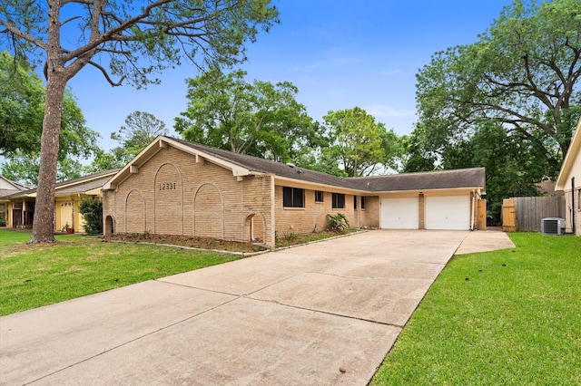 ranch-style house featuring a garage, fence, a front yard, brick siding, and concrete driveway