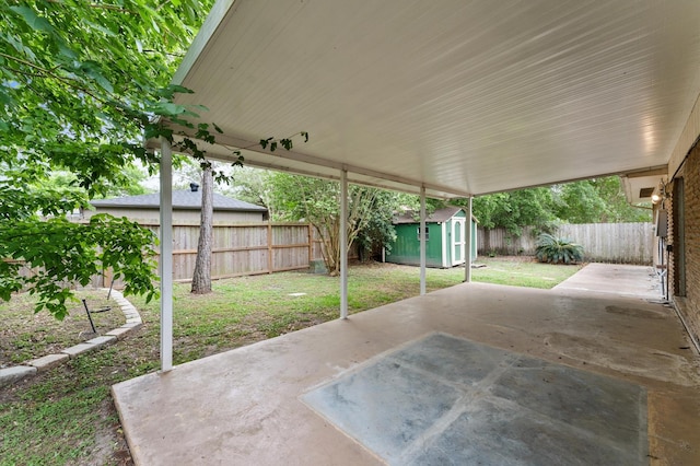 view of patio with an outbuilding, a fenced backyard, and a storage unit