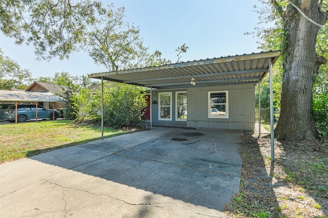 5746 Lakefield Dr, Houston, TX 77033 - rear view of house featuring concrete driveway and a yard