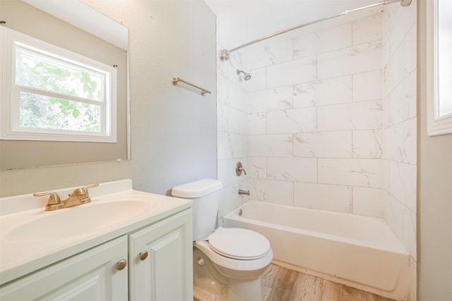 full bathroom with toilet, washtub / shower combination, wood finished floors, and vanity
