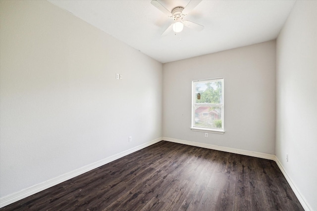 spare room with baseboards, a ceiling fan, and dark wood finished floors