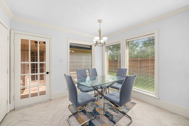 dining area featuring baseboards, ornamental molding, a notable chandelier, and a wealth of natural light