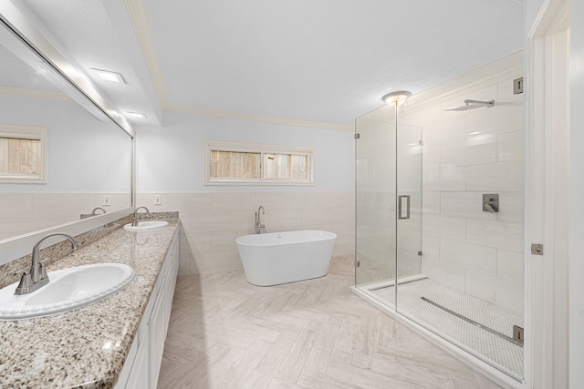 full bathroom featuring a sink, a stall shower, a soaking tub, and tile walls