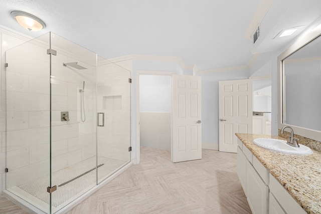 full bathroom with vanity, a stall shower, and visible vents