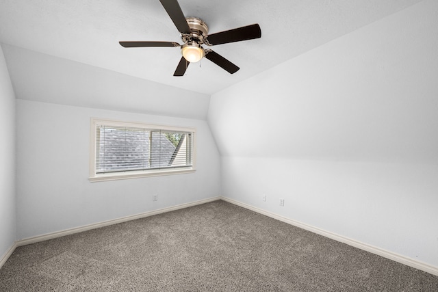 additional living space with carpet flooring, ceiling fan, vaulted ceiling, and baseboards