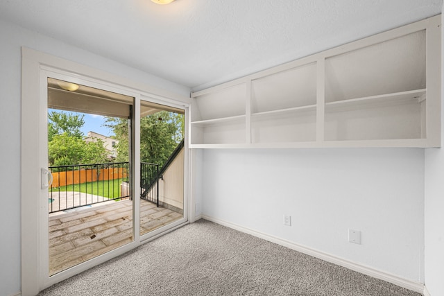 interior space featuring baseboards and carpet