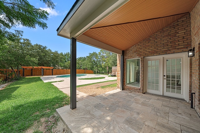 view of patio / terrace with a fenced in pool, french doors, and a fenced backyard