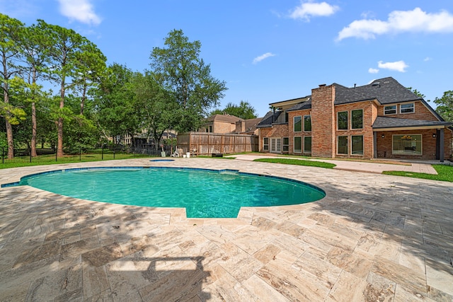 view of pool with a patio, an in ground hot tub, a fenced in pool, and a fenced backyard